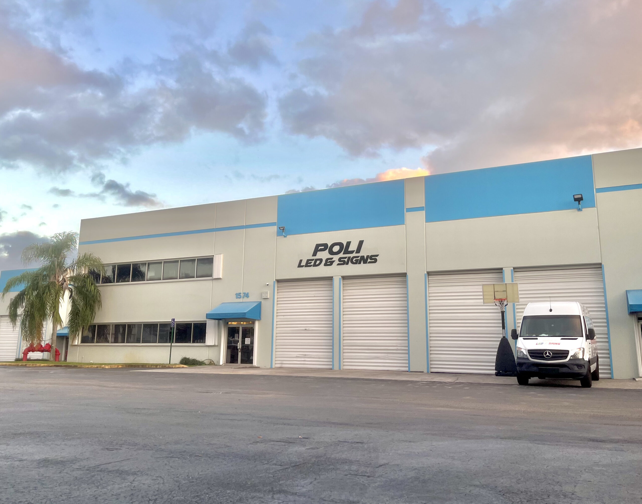 Exterior view of Poli LED & Signs store located at 1574 NW 108th Ave, Miami, FL, 33017. The storefront features a welcoming entrance with prominent LED displays.